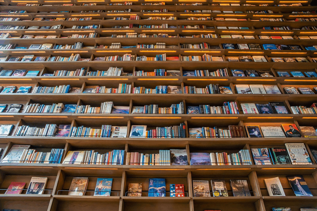 an upward-looking view of an enormous bookshelf with books stretching toward heaven