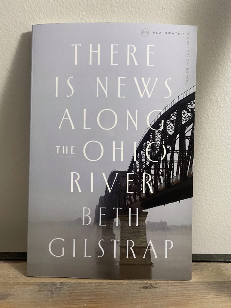 a book, There Is News Along The Ohio River by Beth Gilstrap, on a shelf
