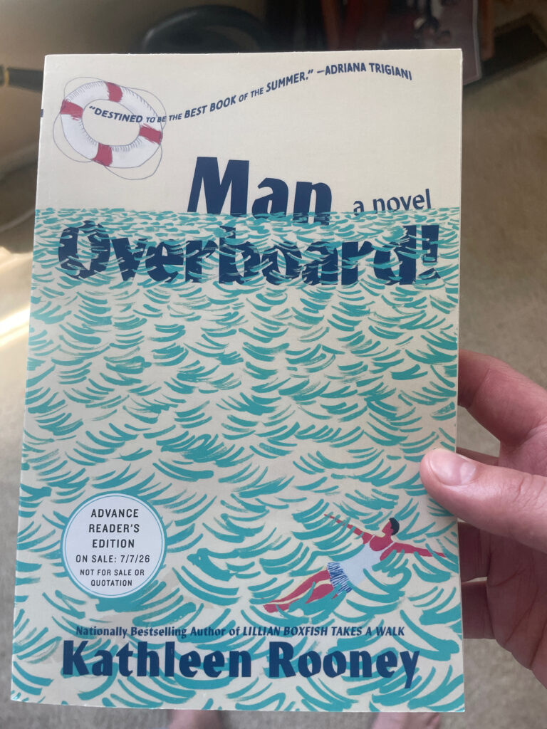 a book, Man Overboard! by Kathleen Rooney, held in a hand