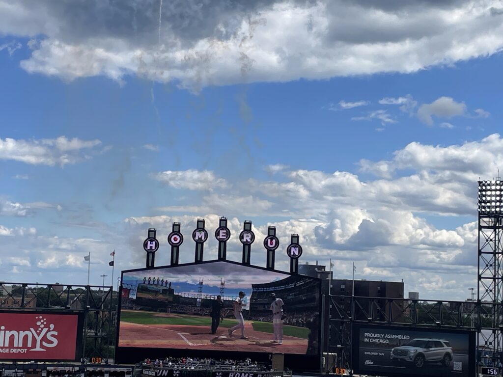 the lollipops at Comiskey Park spelling out home run as a white-jerseyed White Sox player touches home plate