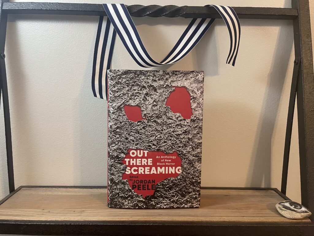 a book, Out There Screaming, on a shelf