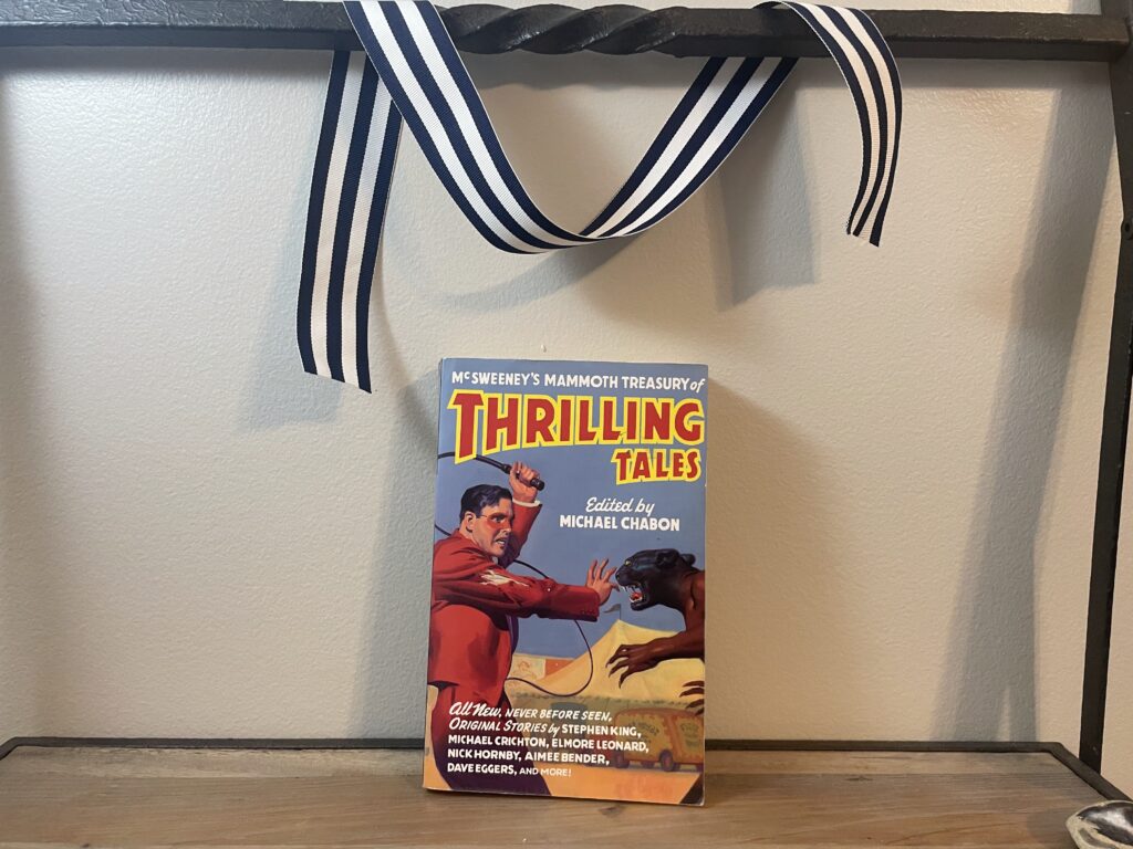 a book, McSweeney's Mammoth Treasury of Thrilling Tales, on a shelf