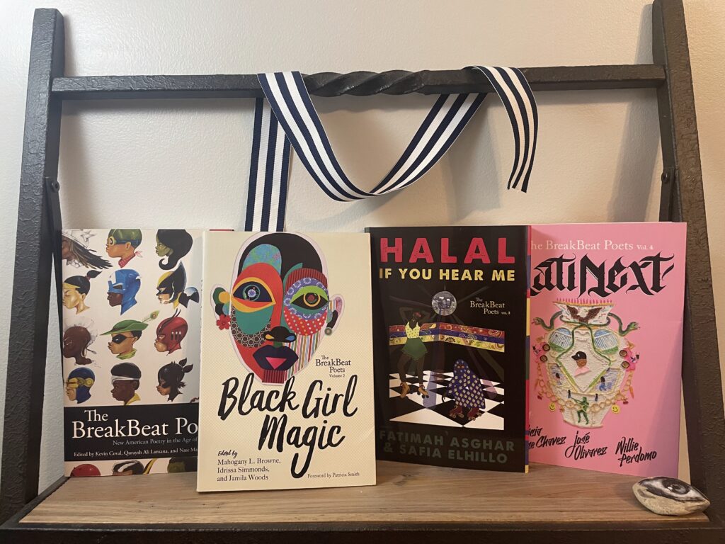 four books, The BreakBeat Poets, Black Girl Magic, Halal If You Hear Me, and LatiNext, on a shelf
