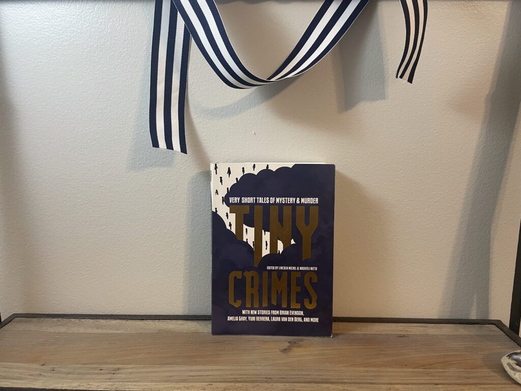 a book, Tiny Crimes, on a shelf