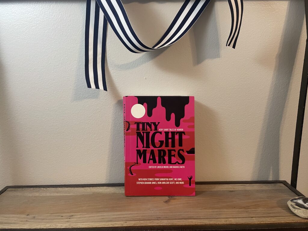 a book, Tiny Nightmares, on a shelf