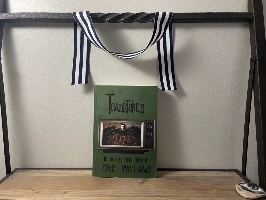 a book, TOADSTONES by Eric Williams, on a shelf