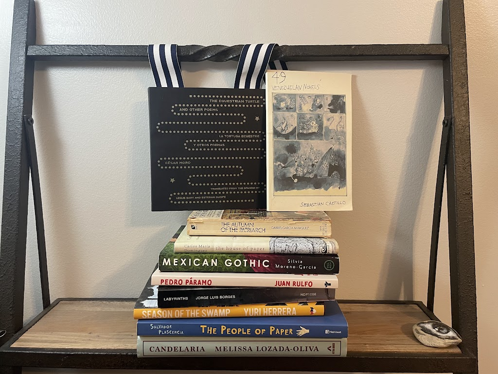 a pile of books, all mentioned in this column, on a shelf
