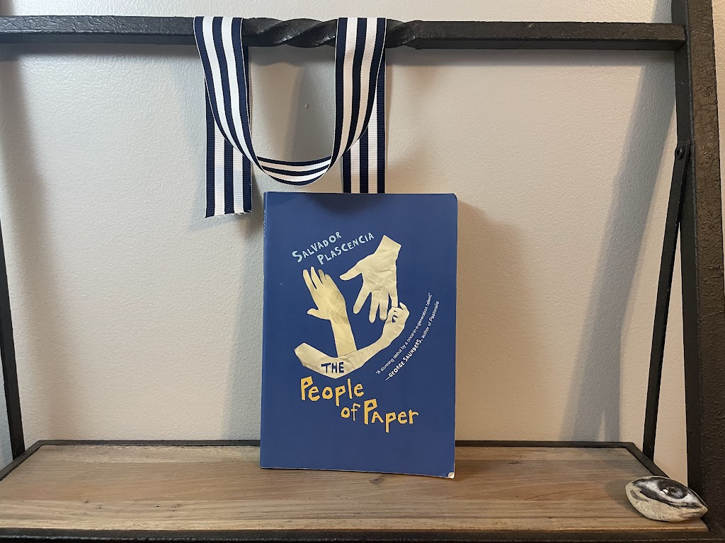 a book, THE PEOPLE OF PAPER by Salvador Plascencia, on a shelf