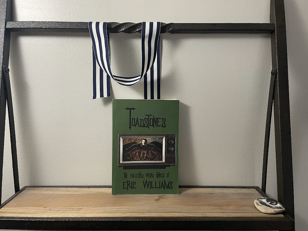 a book, TOADSTONES by Eric Williams, on a shelf