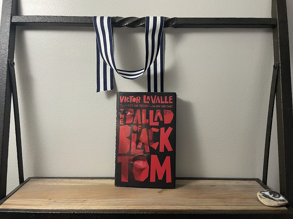 a book, THE BALLAD OF BLACK TOM by Victor LaValle, on a shelf