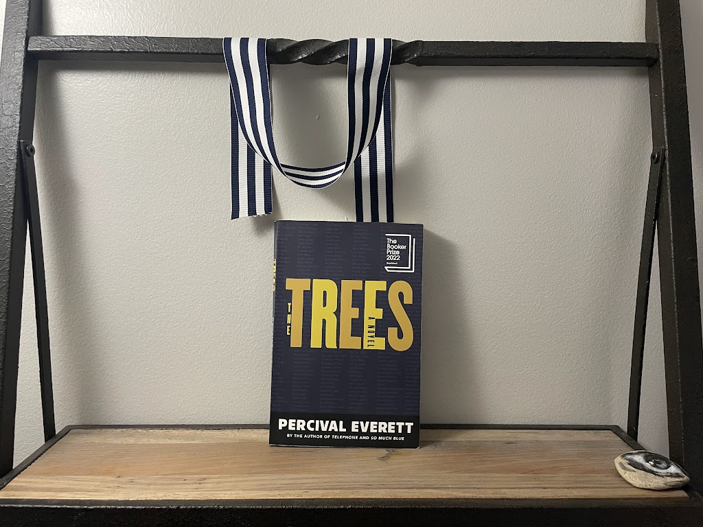 a book, The Trees by Percival Everett, on a shelf